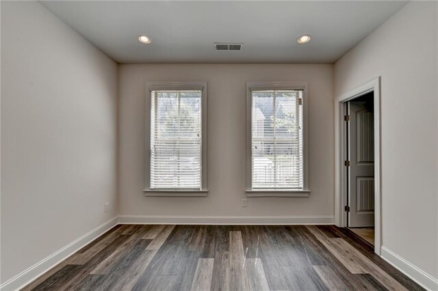 spare room with dark hardwood / wood-style flooring