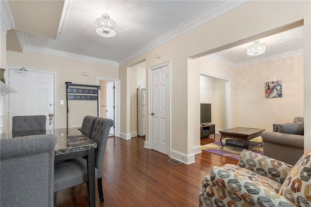 2840 Peachtree Rd NW Unit 307, Atlanta, GA 30305 - living area featuring dark wood-style floors, baseboards, a chandelier, and ornamental molding