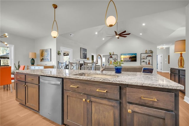 kitchen featuring dishwasher, lofted ceiling, ceiling fan with notable chandelier, sink, and light stone countertops