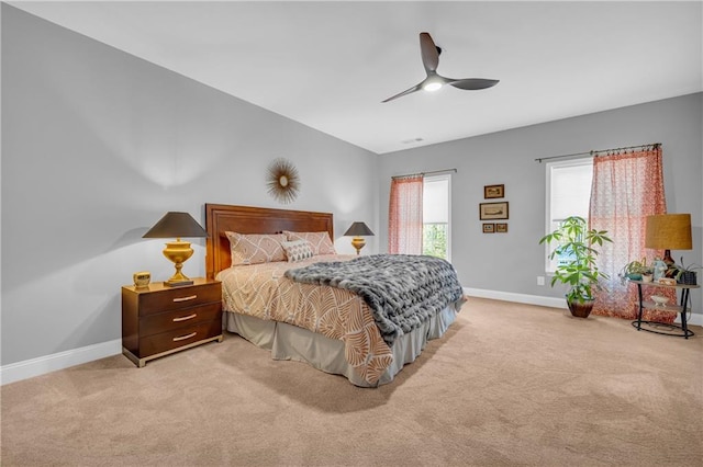 bedroom featuring ceiling fan and light carpet