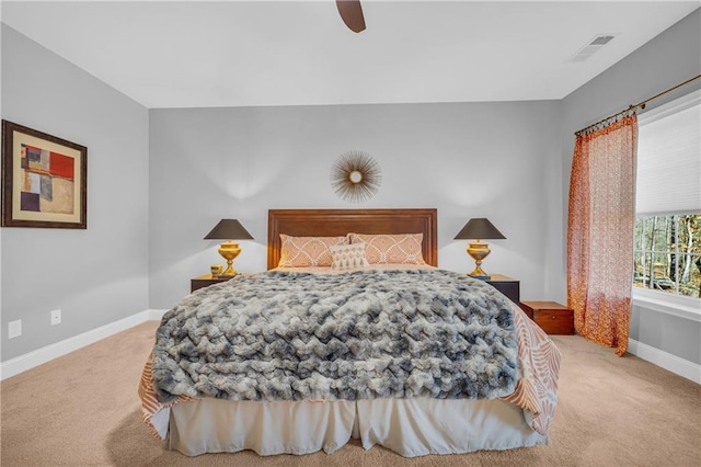 bedroom featuring ceiling fan and light carpet