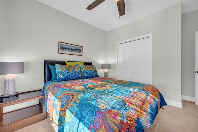 bedroom featuring ceiling fan, light carpet, and a closet