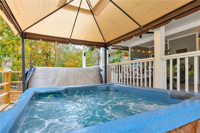 view of swimming pool featuring a gazebo and a hot tub