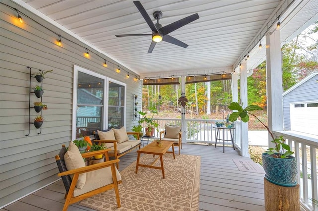 wooden deck with an outdoor living space, a porch, and ceiling fan