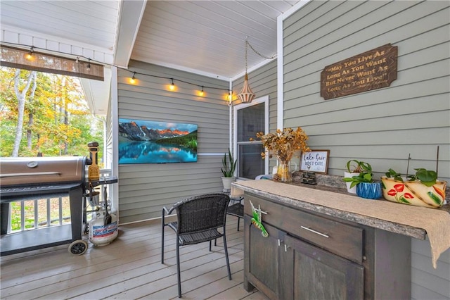 wooden deck featuring a grill