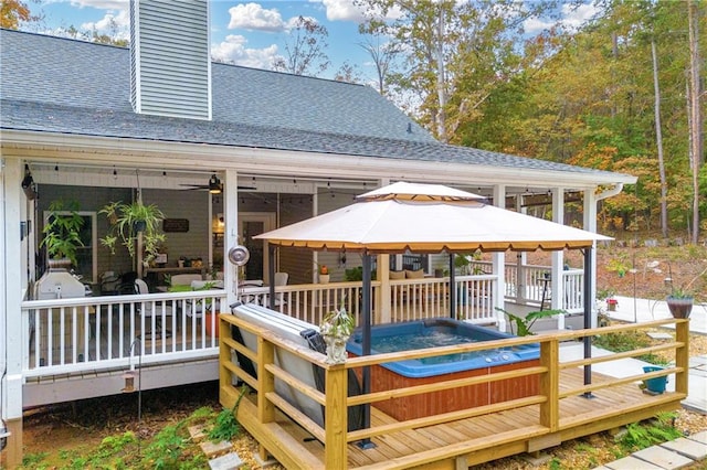 wooden deck with a gazebo, ceiling fan, and a hot tub