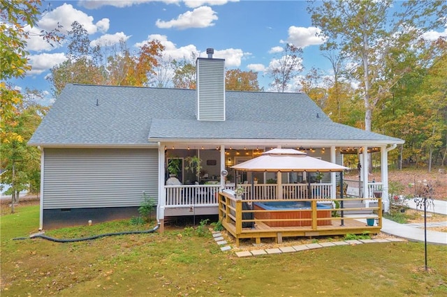 rear view of house with a lawn, a gazebo, and a wooden deck