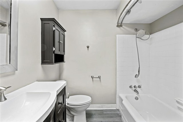 full bathroom with vanity, wood-type flooring, shower / bathtub combination, and toilet