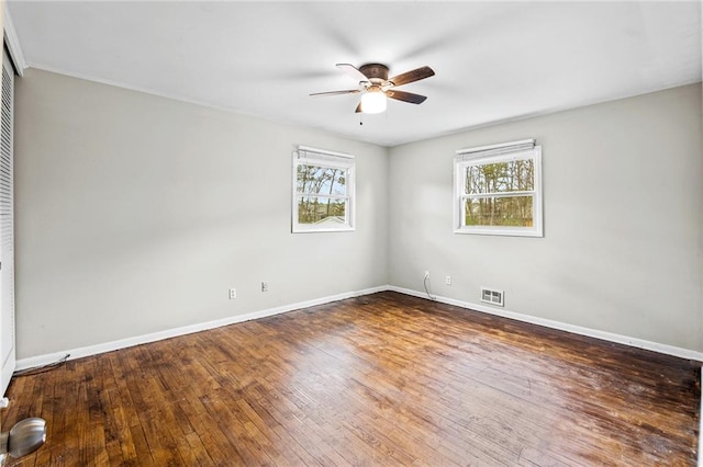 empty room featuring dark hardwood / wood-style floors and ceiling fan