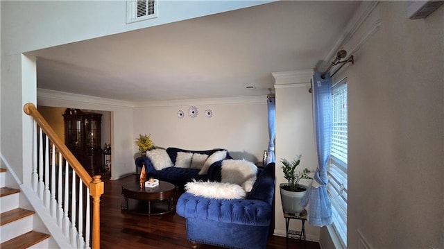 living room featuring dark hardwood / wood-style flooring and ornamental molding