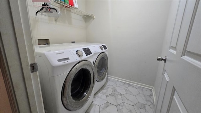 clothes washing area featuring washer and dryer