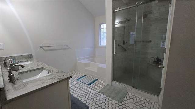 bathroom featuring lofted ceiling, vanity, shower with separate bathtub, and tile patterned flooring