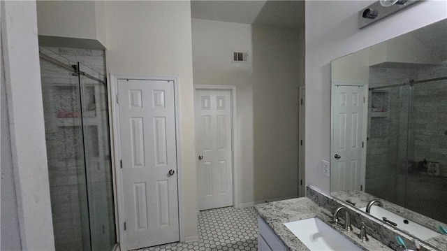 bathroom featuring vanity, tile patterned floors, and a shower with door