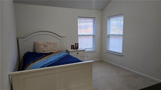 carpeted bedroom with vaulted ceiling