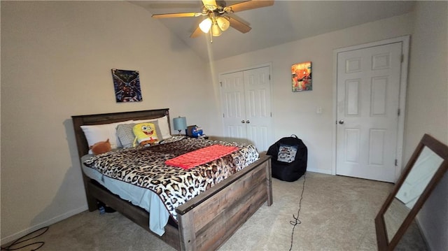 bedroom with vaulted ceiling, a closet, ceiling fan, and carpet