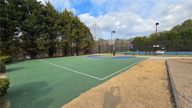 view of sport court featuring tennis court