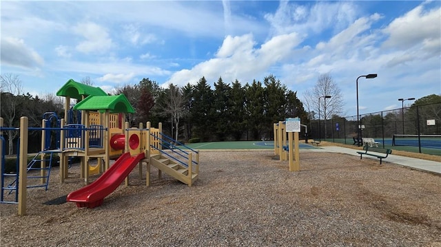 view of jungle gym featuring tennis court