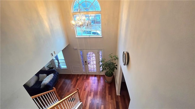 entryway featuring a high ceiling, a chandelier, and dark hardwood / wood-style flooring