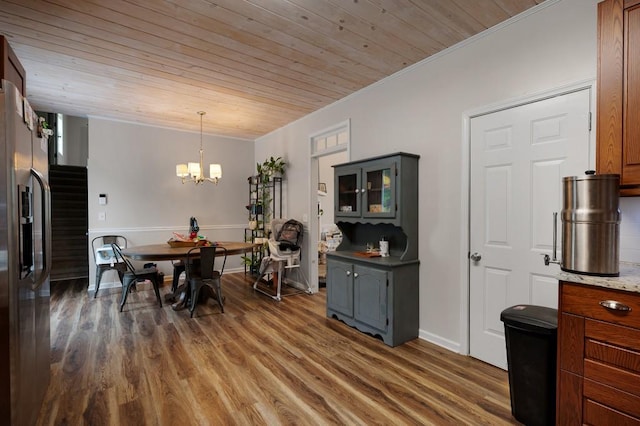 dining area featuring wood ceiling, a chandelier, and wood finished floors