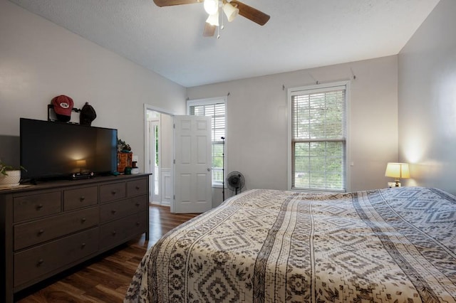 bedroom with ceiling fan and dark wood-type flooring
