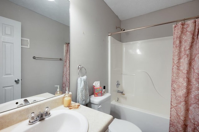 bathroom with vanity, shower / tub combo, visible vents, and toilet