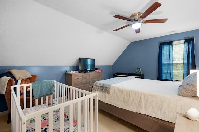 bedroom featuring a ceiling fan and lofted ceiling