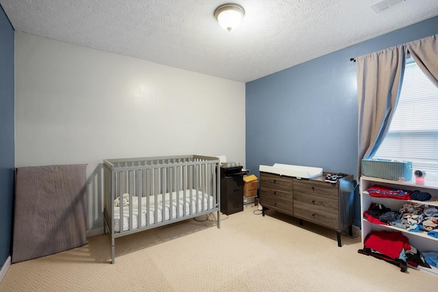 carpeted bedroom with a textured ceiling and visible vents
