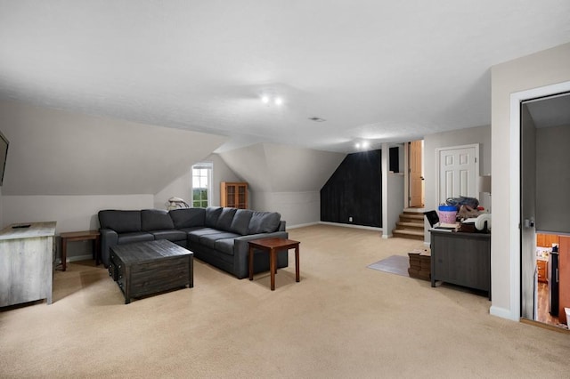 living room featuring baseboards, vaulted ceiling, stairs, and light colored carpet
