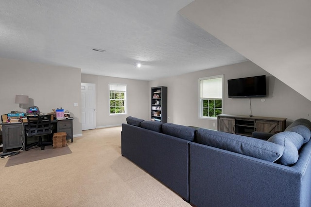 living room featuring a textured ceiling, baseboards, visible vents, and light carpet