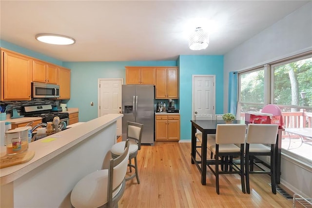 4321 Clairesbrook Ln, Acworth, GA 30101 - kitchen featuring appliances with stainless steel finishes, light wood-style floors, and light brown cabinets