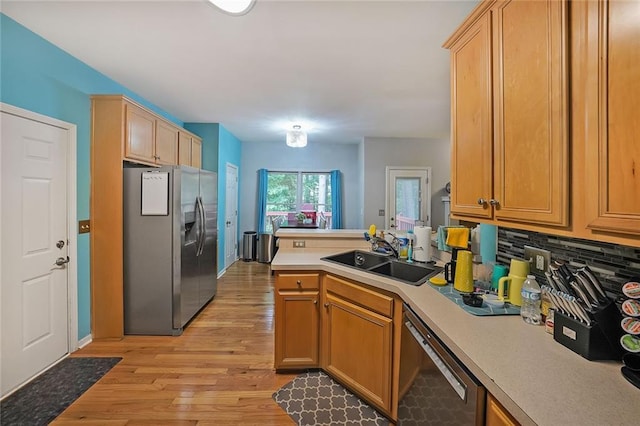4321 Clairesbrook Ln, Acworth, GA 30101 - kitchen with stainless steel appliances, a sink, a peninsula, light countertops, and light wood-style flooring