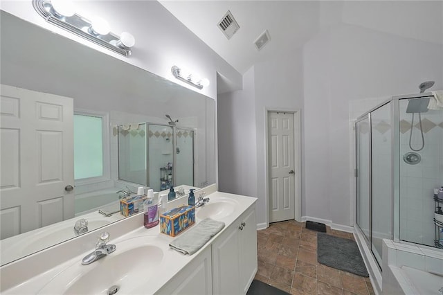 4321 Clairesbrook Ln, Acworth, GA 30101 - bathroom featuring a stall shower, double vanity, lofted ceiling, a bath, and stone finish floors