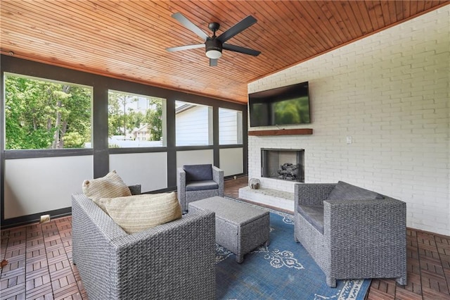 sunroom / solarium featuring vaulted ceiling, an outdoor brick fireplace, ceiling fan, and wood ceiling