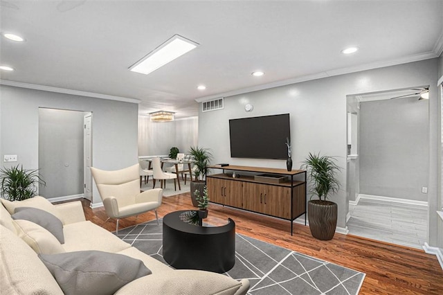 living room featuring ornamental molding, dark hardwood / wood-style floors, and ceiling fan