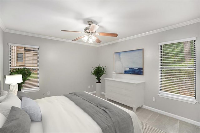 carpeted bedroom with crown molding and ceiling fan