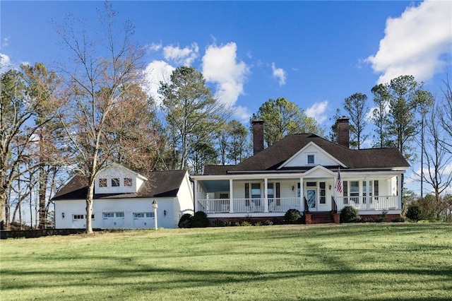 view of front of house featuring a garage, covered porch, a chimney, and a front lawn