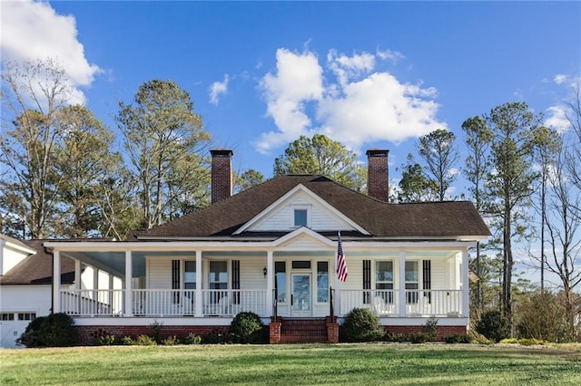 farmhouse with a porch, a chimney, and a front yard