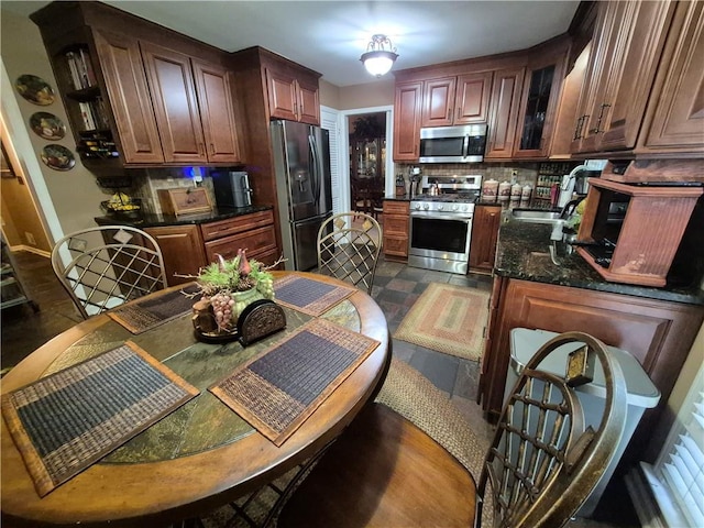 4094 Carlisle Pl, Stone Mountain, GA 30083 - kitchen with stainless steel appliances, decorative backsplash, glass insert cabinets, and dark stone counters