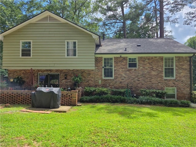 4094 Carlisle Pl, Stone Mountain, GA 30083 - rear view of house with brick siding, a lawn, and a shingled roof