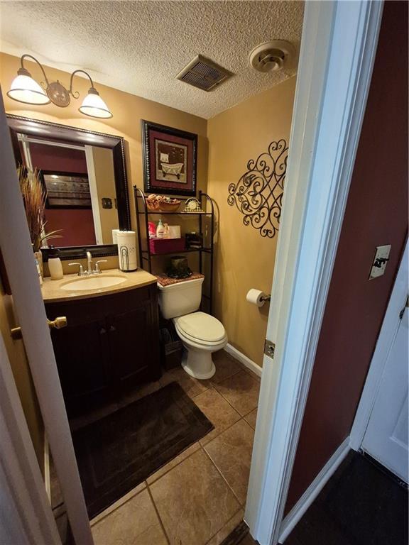 4094 Carlisle Pl, Stone Mountain, GA 30083 - bathroom featuring vanity, tile patterned floors, and a textured ceiling