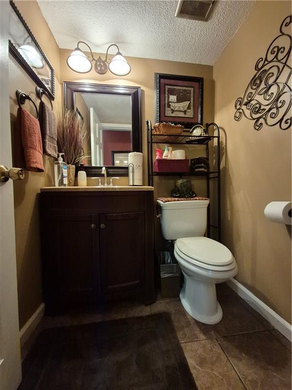 4094 Carlisle Pl, Stone Mountain, GA 30083 - bathroom with a textured ceiling and vanity