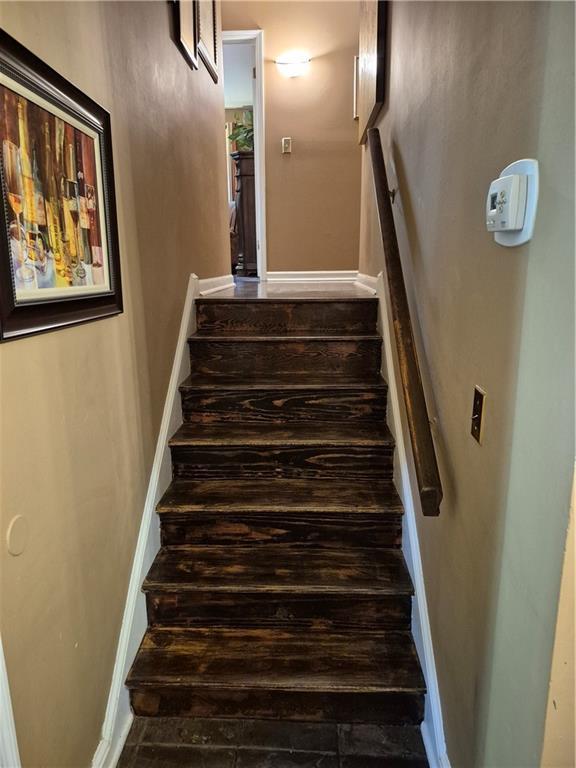 4094 Carlisle Pl, Stone Mountain, GA 30083 - stairs featuring baseboards