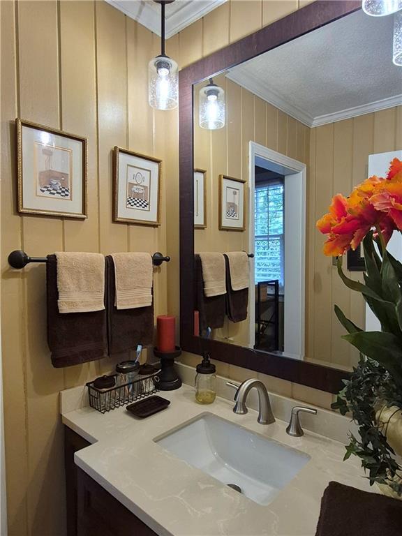 4094 Carlisle Pl, Stone Mountain, GA 30083 - bathroom featuring crown molding and vanity