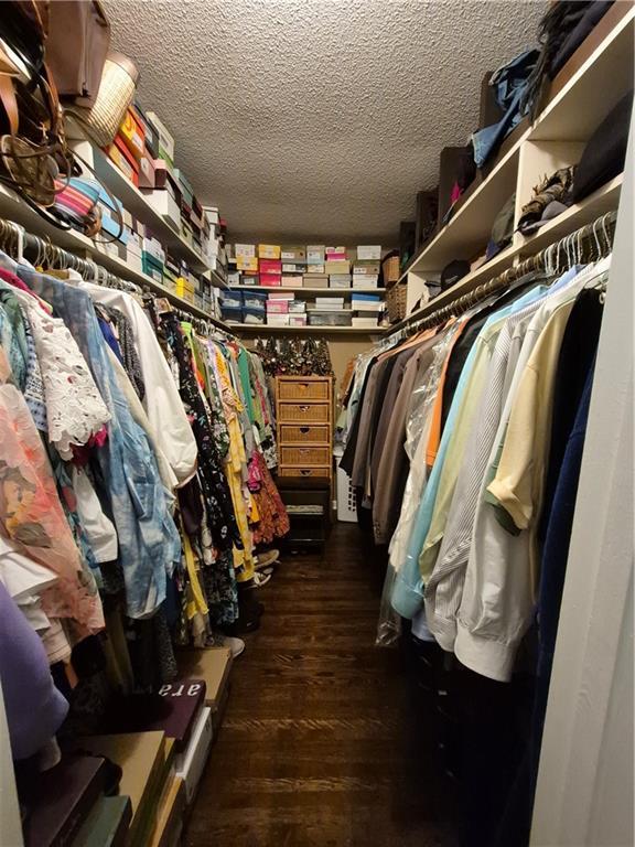 4094 Carlisle Pl, Stone Mountain, GA 30083 - walk in closet with dark wood-style floors