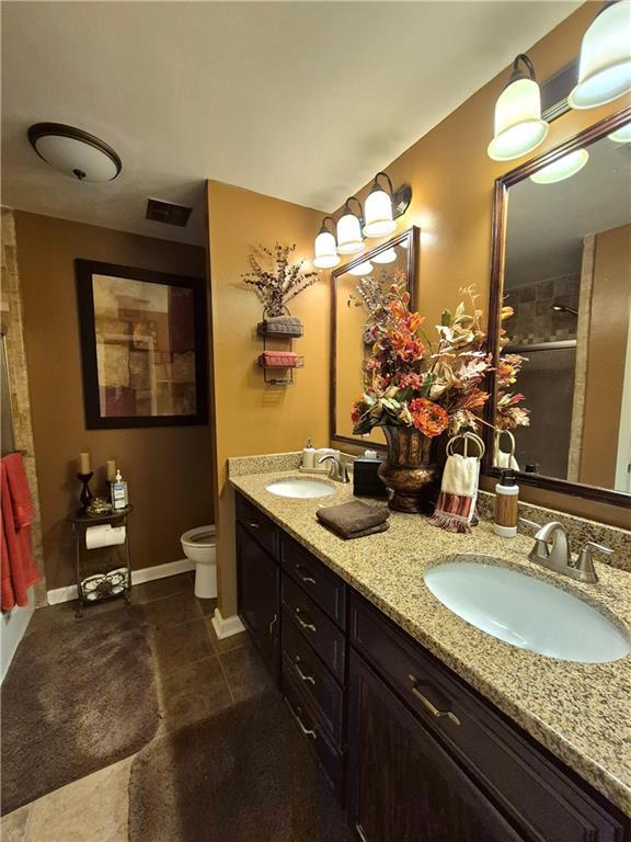 4094 Carlisle Pl, Stone Mountain, GA 30083 - full bathroom featuring double vanity, a stall shower, and tile patterned floors