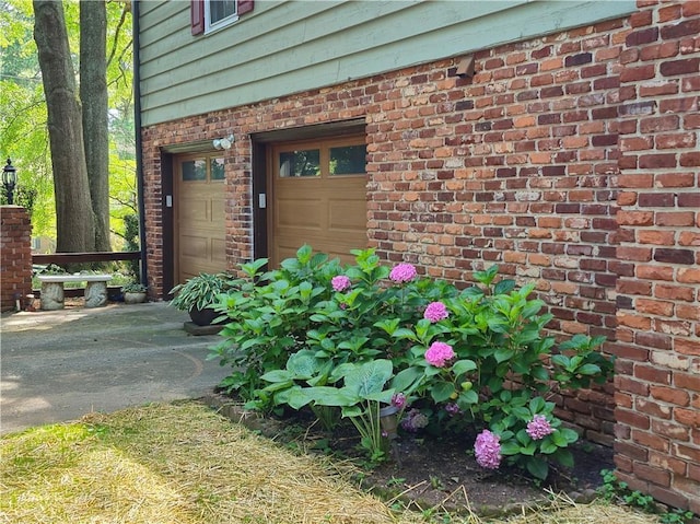 4094 Carlisle Pl, Stone Mountain, GA 30083 - property entrance with driveway, brick siding, and a garage