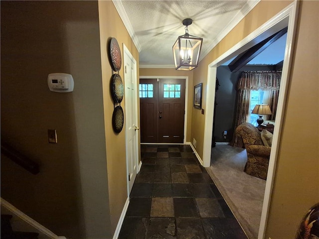 4094 Carlisle Pl, Stone Mountain, GA 30083 - entryway with ornamental molding, dark stone finish flooring, a chandelier, and dark colored carpet