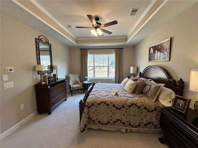 bedroom with visible vents, ornamental molding, ceiling fan, light colored carpet, and a raised ceiling