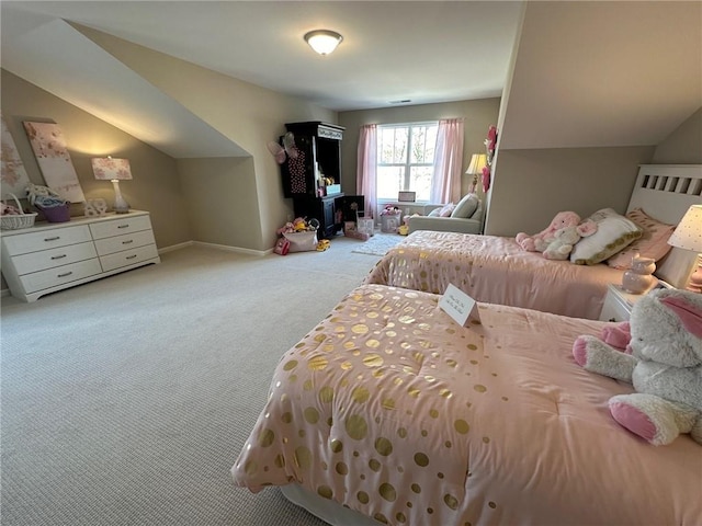 bedroom featuring baseboards, carpet flooring, and vaulted ceiling