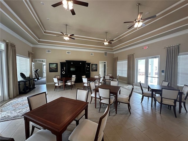 dining space featuring ceiling fan, visible vents, and a tray ceiling